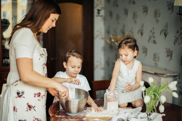 Homeschool mom baking something with her kids
