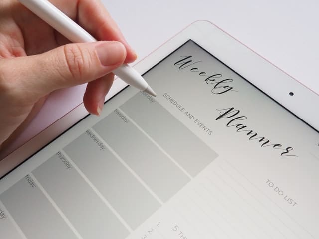 Digital weekly homeschool planner on a tablet with stylus