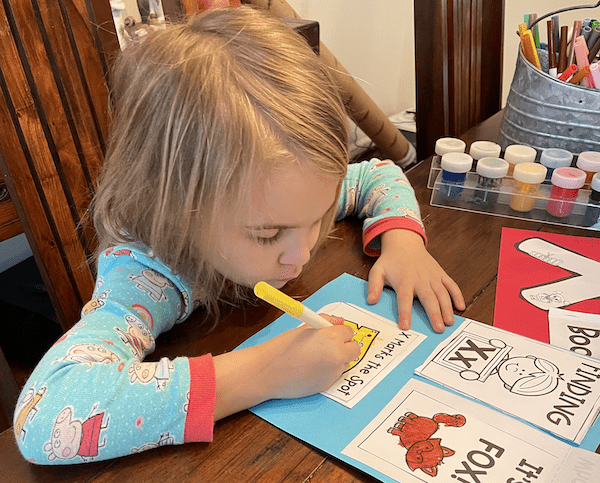 a young girl doing preschool 