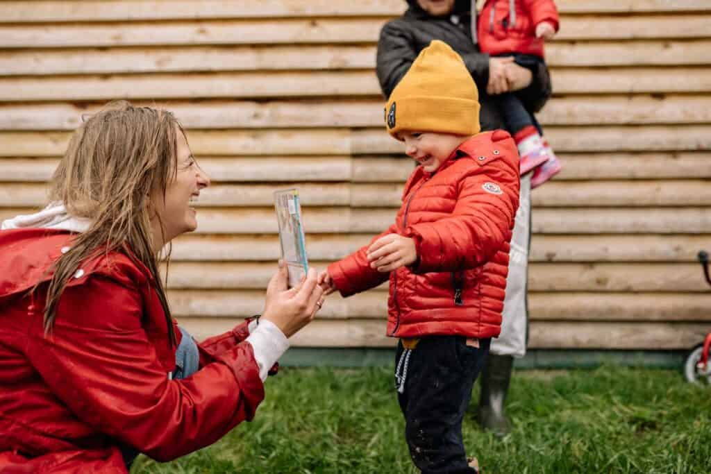 Girl in Red Jacket Holding Clear Drinking Glass