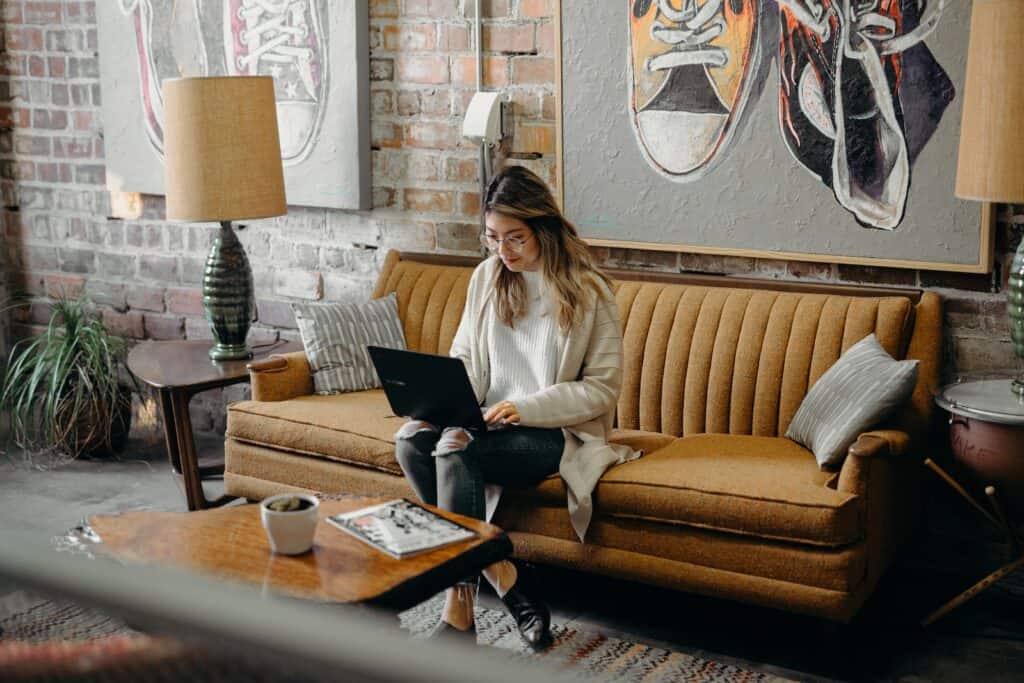 woman using laptop while sitting on chair working on homeschool planning time