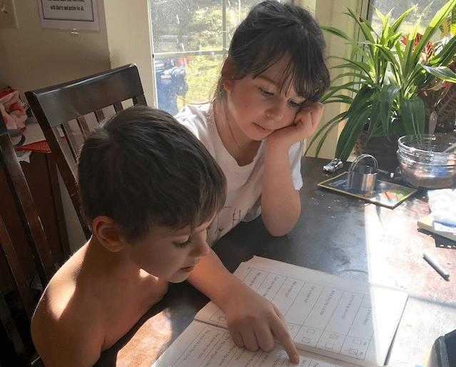 two kids reading homeschooling books. organization 