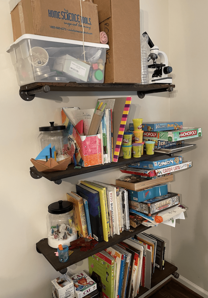 messy shelves before organize homeschool supplies
