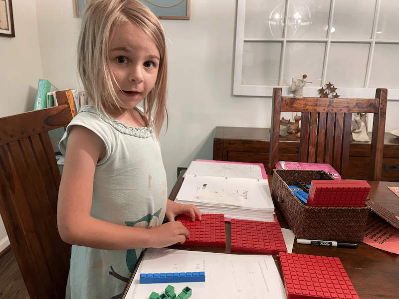 girl doing her math curriculum for homeschooling kindergarten