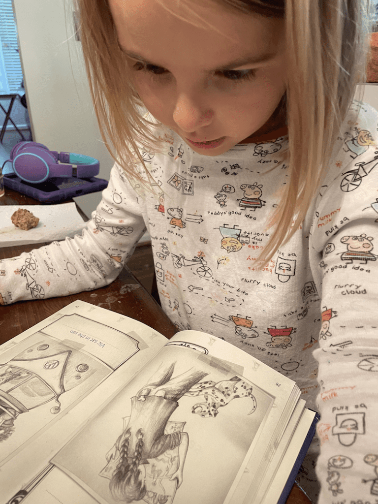 kindergarten girl reading her reading curriculum for kindergarten homeschool