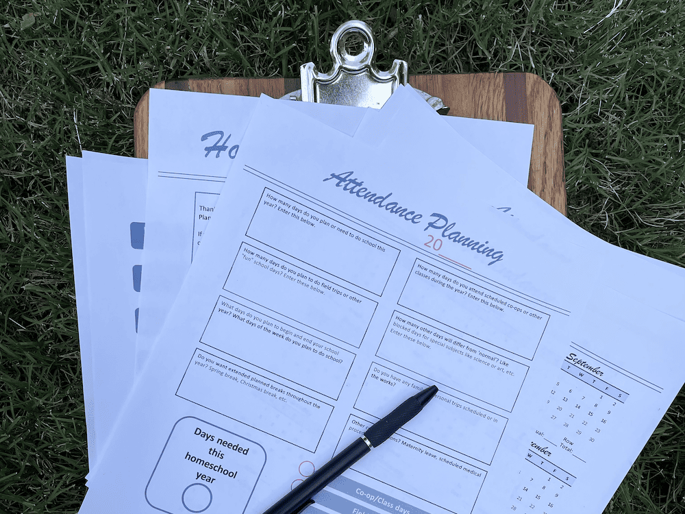 Free printable attendance sheets picture on clipboard in the grass