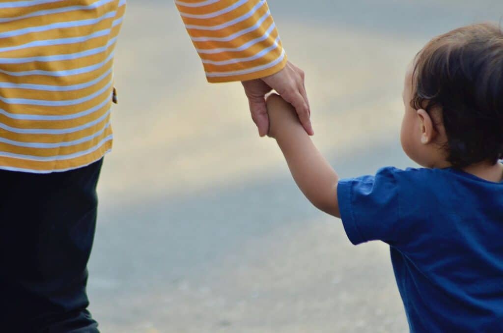 child, mother, holding hands walking