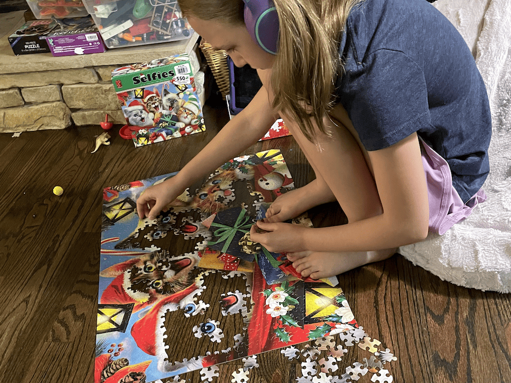 young girl doing a cat puzzle