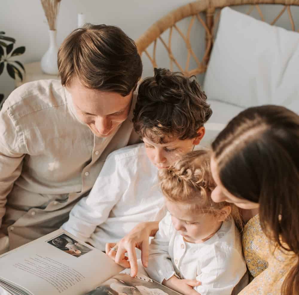 mom and kids reading a book