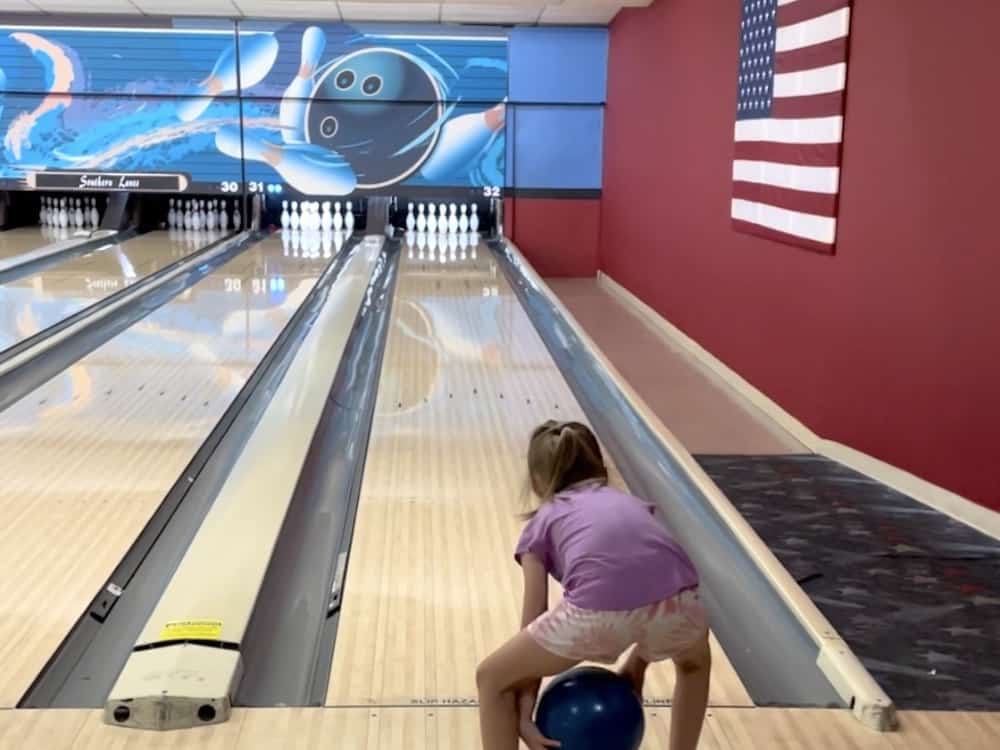 young girl bowling