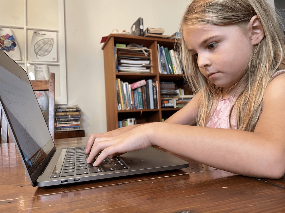 girl doing an online homeschool program