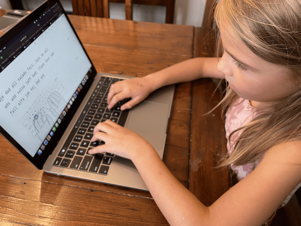 Young girl typing on a computer