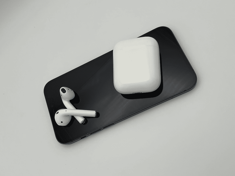 iphone with white apple AirPods on it