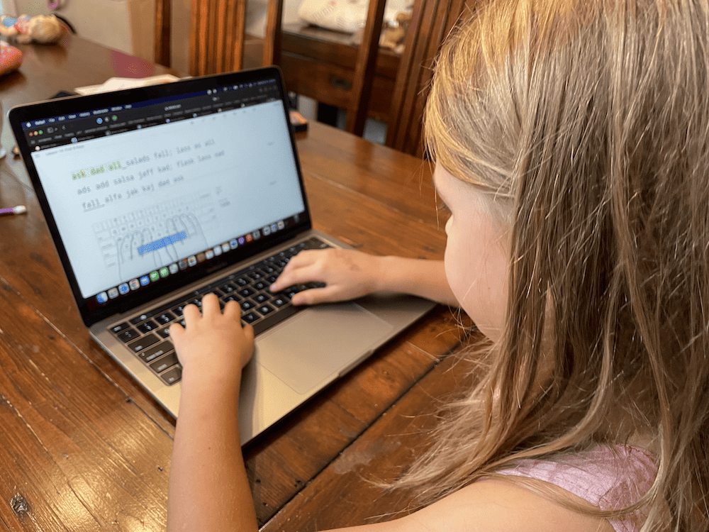 girl typing on a computer typing program