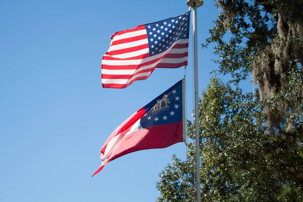 USA flag and Georgia flag flying in the wind