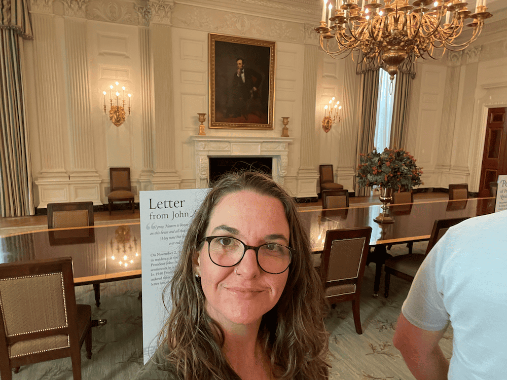 woman standing in the white house state dining room