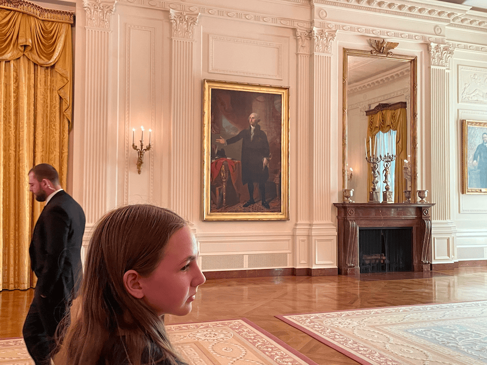 girl in the white house with a painting of Washington